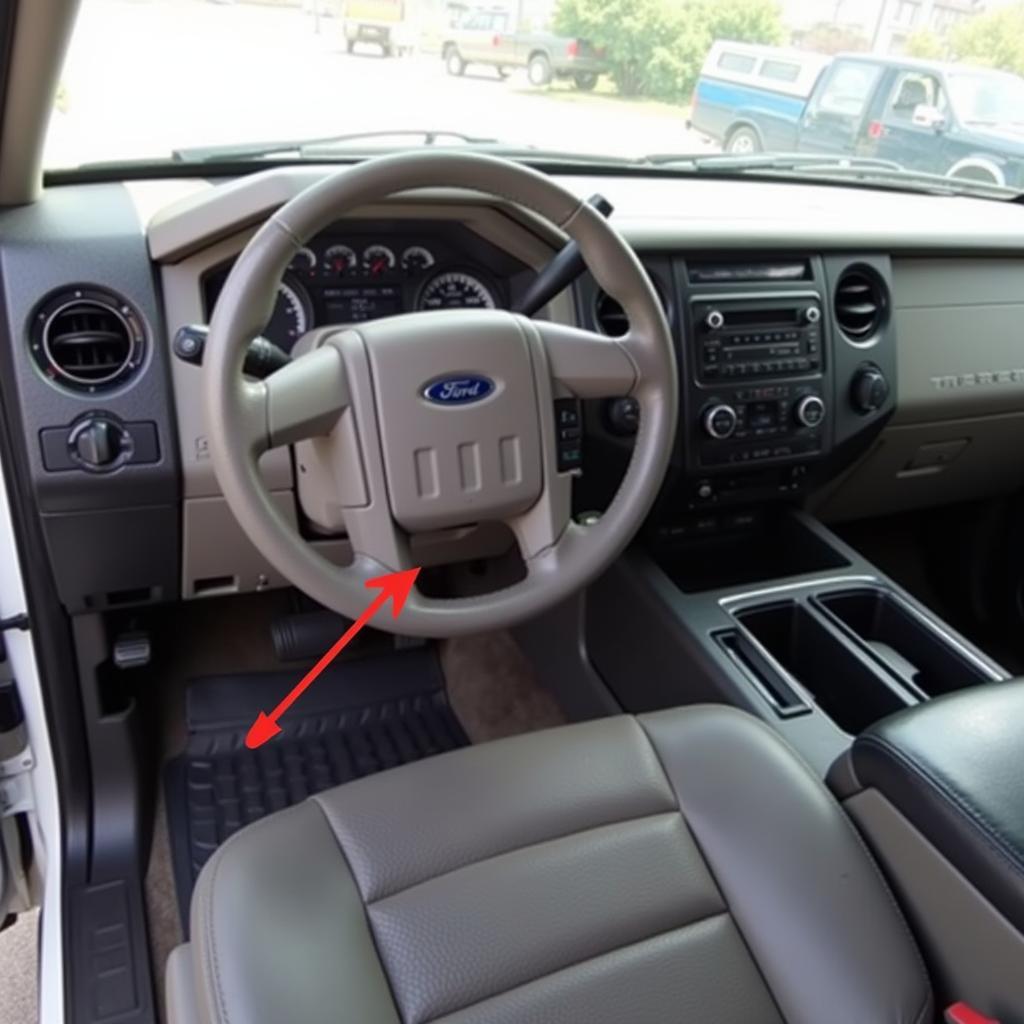 OBD-II Port Location in a 2013 Ford F350: Highlighting the location of the OBD-II port inside the truck's cabin.