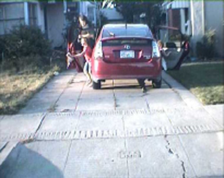 An image taken by a license plate reader on a San Leandro, Calif., police car shows Mike Katz-Lacabe and his daughters getting out of their Toyota Prius in their driveway. The image is one of 112 that Katz-Lacabe received in a 2010 public records request for license plate data on his vehicles collected by police.