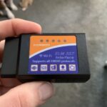 Kobra OBD2 Scanner displayed at an angle, showcasing its compact design and OBDII connector.