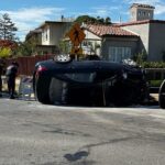 Wrecked car being stabilized by Berkeley Fire Department personnel after Marin Circle collision