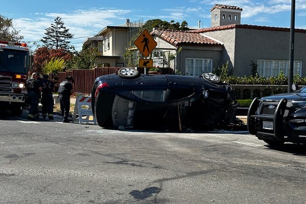 Wrecked car being stabilized by Berkeley Fire Department personnel after Marin Circle collision