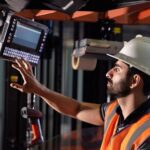 Technician installing a scanner in a vehicle.