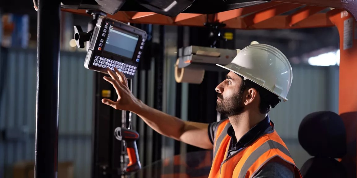 Technician installing a scanner in a vehicle.